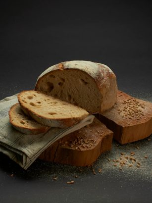 Sliced sourdough bread on a rustic surface, showcasing homemade culinary artistry.