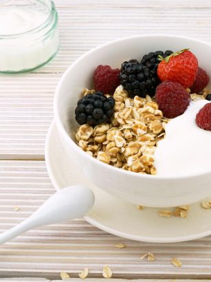 Delicious granola bowl topped with fresh berries and yogurt, perfect for a healthy breakfast.